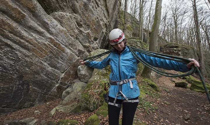 Hana Rice, a guide with U.S. Military Outdoor Recreation, secures a climbing rope after repelling from an approximate 35 foot rock face within the National Network of Footpaths in the Grand-Duchy of Luxembourg. Members of the climbing party were required to wear the appropriate climbing helmet and safety harness in order to prevent possible injuries such as traumatic brain injury. TBI awareness is observed throughout the month of March in hopes of spreading awareness of the trauma and potentially preventing future cases. (Air Force photo by Tech. Sgt. Brian Kimball)