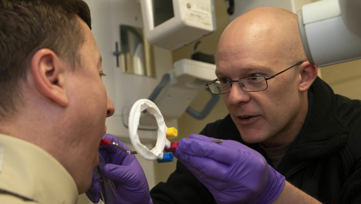 Good dental hygiene is essential to keeping the armed forces healthy. Navy Hospital Corpsman 3rd Class Kyle Gladding, from Montgomery, Alabama, assigned to USS Gerald R. Ford's dental department, prepares a patient for a dental x-ray. (U.S. Navy photo by Mass Communication Specialist 2nd Class Brigitte Johnston)