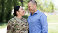 Military personnel smiles with spouse