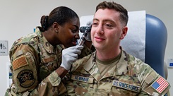 An Airman with the 21st Medical Group, left, examines a U.S. Space Force Guardian during training
