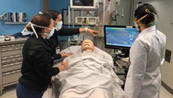 Military health personnel reading a medical machine