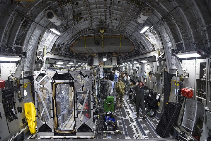 A C-17 Globemaster III is prepped to transport a Transportation Isolation System during a training exercise that allows Airmen to practice the most effective and safest form of transportation for patients and their medical professionals. Engineered and implemented after the Ebola virus outbreak in 2014, the TIS is an enclosure the Defense Department can use to safely transport patients with highly contagious diseases. (U.S. Air Force photo by Senior Airman Cody Miller)