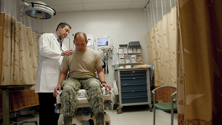 Sean Harap, Tripler Army Medical Center physician, performs a physical exam for U.S. Air Force Capt. Joshua Gscheidmeier, 128th Air Refueling Wing, at Tripler Army Medical Center May 8, 2014, in Honolulu.  (U.S. Air Force photo by Staff Sgt. Christopher Hubenthal)