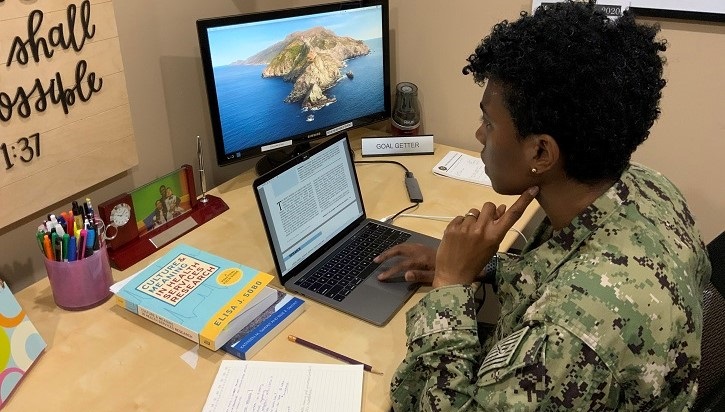 Image of soldier sitting at desk looking at laptop