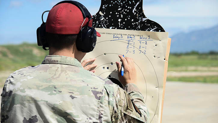 An Air Force Airman inspects a target used during a shooting competition at Davis-Monthan Air Base, Arizona, in 2021. The True North program is a resilience program that embeds providers and spiritual leaders within squadrons and groups. Davis-Monthan implemented True North in October 2020. (Photo: Air Force Airman 1st Cl. William Turnbull)