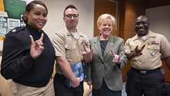 University of South Florida President Rhea Law, and navy talent acquisition group Miami sailors pose for a photo making the USF Bulls mascot hand sign during a visit to the Tampa campus on Dec. 4, 2024. USF Navy Medicine leadership and NTAG Miami Sailors had the opportunity to engage with students, highlight the benefits of naval service, and strengthen their partnership. (Photo by U.S. Navy Mass Communication Specialist 1st Class Natalia Murillo)