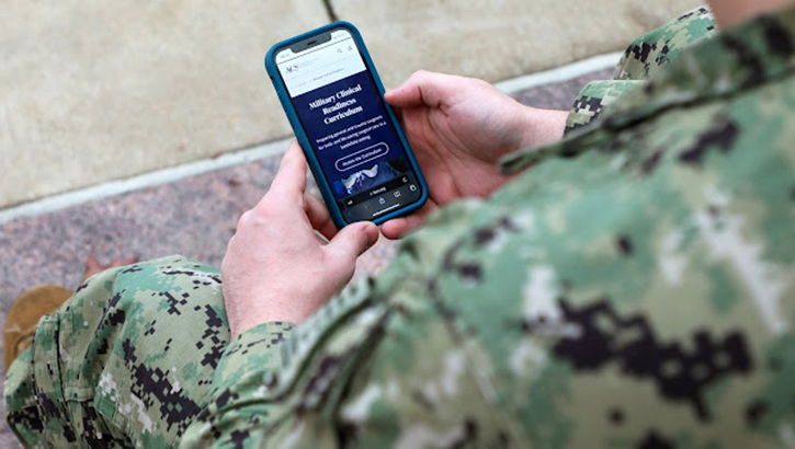 Military personnel holding new device developed by USU