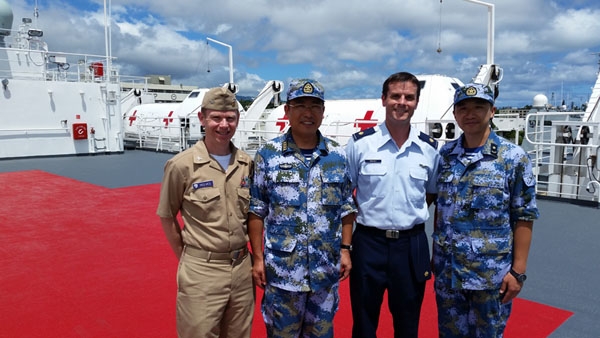 Navy Capt. (Dr.) Jamie Reeves (left) and Air Force Major (Dr.) Geoff Oravec (center, right), of the Uniformed Services University's Center for Global Health Engagement participated in Exercise RIMPAC 2016 with Captain Sun Tao, head of the medical element of the Chinese hospital ship Peace Ark. During the exercise, CGHE delivered its Fundamentals for Global Health Engagement course, which brought together about 30 Chinese Navy medical officers with medical officers from Australia, Canada, and the US Navy.  (Uniformed Services University photo)