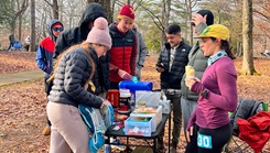 A "pit crew" of USU students and running community members manages nutrition and hydration supplies at an aid station