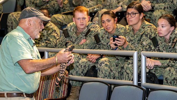 Military Tropical Medicine course students get an up-close view of a venomous reptile held by herpetologist Bruce Shwedick