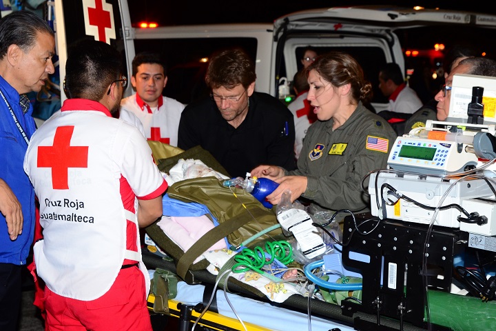Members of the U.S. Air Force Critical Care Air Transport Team (Pedicatics) assist Guatemalan medical personnel with loading injured patients on board a Mississippi Air National Guard C-17 Globemaster III. The aircrew from the 172nd Airlift Wing, transported six children from Guatemala to receive medical treatment in the United States for burns and other injuries sustained during the June 3, 2018 Fuego Volcano eruption. (U.S. Air Force photo by Tech. Sgt. Edward Staton)