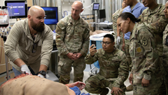 Military medical personnel in operating room setting