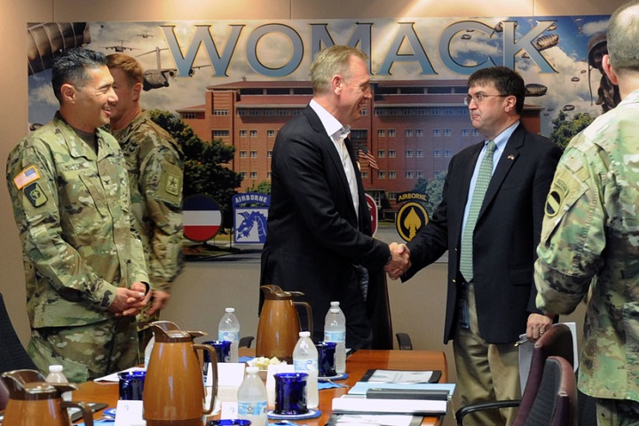 Deputy Defense Secretary Patrick M. Shanahan greets Veterans Affairs Secretary Robert Wilkie as Army Col. John Melton, the commander of Womack Army Medical Center, looks on, at the start of a meeting at Womack Army Medical Center, Fort Bragg, North Carolina, July 26, 2018. Shanahan convened the meeting to discuss medical readiness, as well as how the Defense Health Agency and military services are collaborating on the integration of the Military Health System. (DoD photo by Lisa Ferdinando)