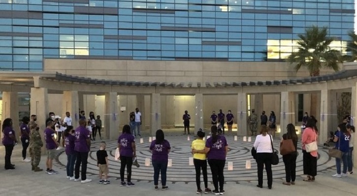 Image of Group of people standing outside hospital. Click to open a larger version of the image.