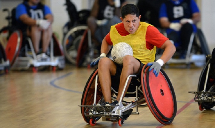 A U.S. Marine Corps Wounded Warrior fights for position as he advances the ball during tournament play. 