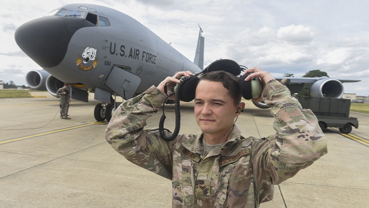 Air Force Senior Airman Joseph Finigan, 100th Aircraft Maintenance Squadron aircraft hydraulics systems journeyman, puts on a second layer of hearing protection over his dual in-ear headset at RAF Mildenhall, England. The headset enables communication by transmitting sound waves through the bones in the user's ear. (U.S. Air Force photo by Airman 1st Class Joseph Barron)