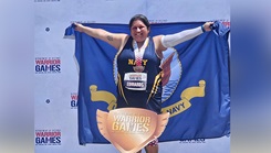 Retired Information Systems Technician U.S. Navy 1st Class Maria Edwards, 41, formerly from Commander Naval Surface Group Middle Pacific and recent Wounded Warrior of the Year 2024 is featured in support of Warrior Care Month; Edwards poses with her bronze medal that she won in the 200-meter run at the Department of Defense Warrior Games in Orlando, Florida in 2024. (Courtesy Photo) 