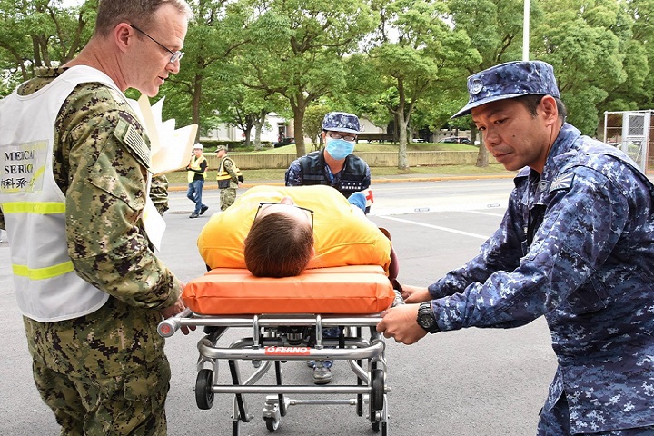 Japan Maritime Self-Defense Force (JMSDF) Sailors and U.S. Naval Hospital (USNH) Yokosuka personnel transport a simulated patient during a mass casualty drill in conjunction with hospital ship USNS Mercy and JMSDF personnel. The drill was conducted in order to prepare medical staff for a mass casualty scenario involving a maritime incident at sea. USNH Yokosuka is the largest U.S. military treatment facility on mainland Japan caring for approximately 43,000 eligible beneficiaries. (U.S. Navy photo by Tim Jensen)