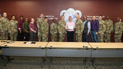 Wally Edwards, center, safety manager for U.S. Army Medical Logistics Command, presents the Army’s Safety Excellence Streamer award for the brigade level to team members