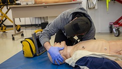 U.S. Navy Hospital Corpsman 1st Class Axel Narvaez, the regional training officer assigned to Naval Medical Forces Atlantic, checks the airway breathing of a simulated patient during a paramedic training scenario