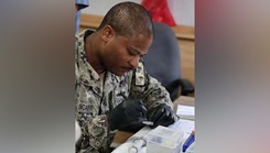 Hospital Corpsman 1st Class Michael Scaife, Naval Medical Research Unit (NAMRU) EURAFCENT lab technician, processes clinical specimens for biosurveillance testing during exercise African Lion