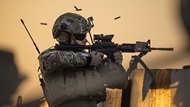 U.S. Air Force Tech. Sgt. Jason Waters, 82nd Expeditionary Air Support Operations Squadron joint terminal attack controller, fires an M-4 carbine at Udairi Range, Kuwait