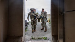 U.S. Air Force and Air National Guard medical personnel move patients