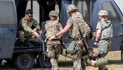 Military medical personnel transport a simulated patient during the Advanced Combat Medical Experience (ACME) field exercise