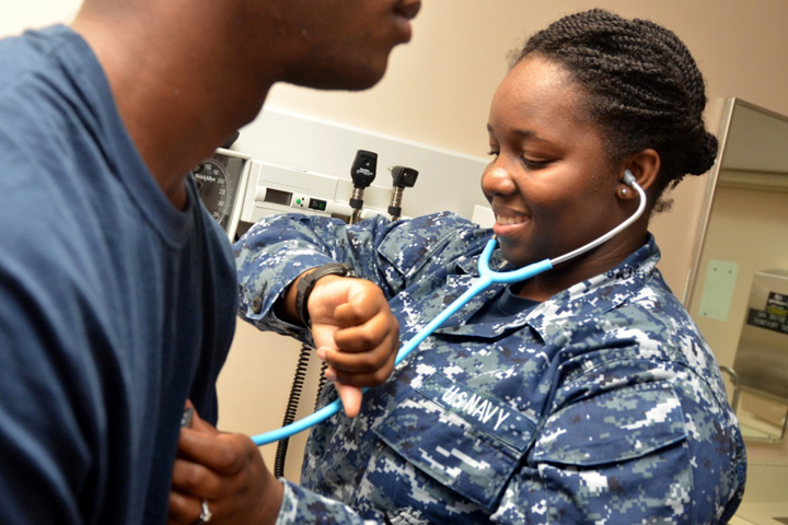 Navy Hospitalman Kiana Bartonsmith checks a patientâ€™s heart rate at Naval Branch Health Clinic Kings Bay in Georgia, one of Naval Hospital Jacksonvilleâ€™s six health care facilities. (U.S. Navy photo by Jacob Sippel)