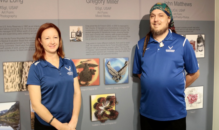 Retired Air Force Staff Sgt. Greg Miller and his wife Heather stand in front of Miller’s three-dimensional art made with wood screws now on display as part of the 2017 Pentagon Patriotic Art Program: Wounded Warrior Healing Arts Exhibit. (Courtesy photo)