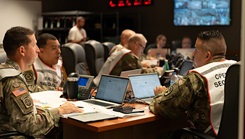 Army Col. Michael Henry, BAMC deputy commander for administration and the incident commander in the hospital command center, monitors the hospitals response during the San Antonio Mass Casualty Exercise and Evaluation at Brooke Army Medical Center
