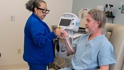 Melissa DeLaCruz, licensed vocational nurse, checks patient David Phillips’s vitals prior to his dive session