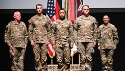 Military personnel pose for picture