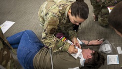 U.S. Air Force Airmen assigned to the 23d Operational Medical Readiness Squadron perform simulated care on a patient during a public health emergency exercise