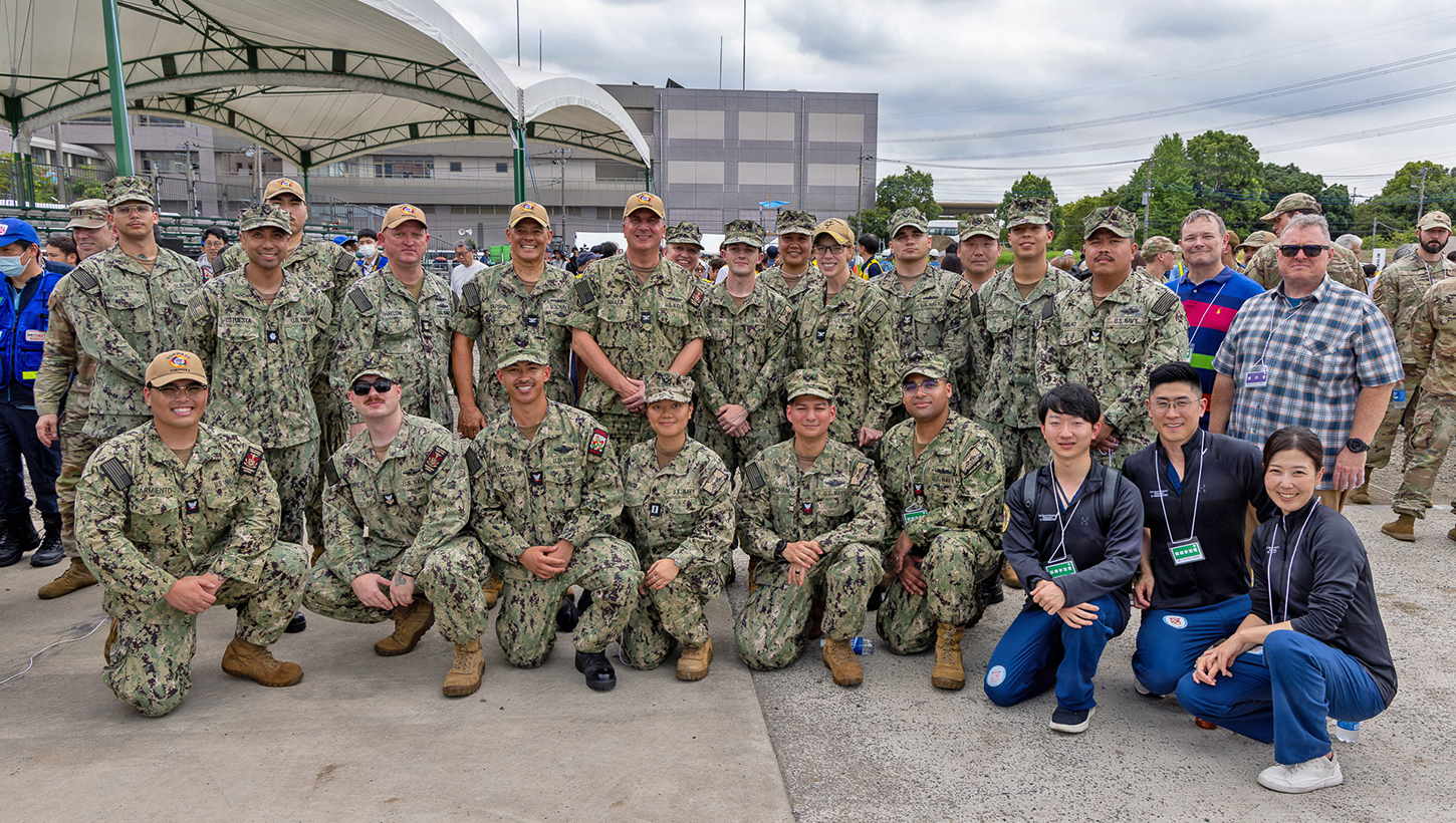 Sailors assigned to U.S. Navy Medicine Readiness and Training Command Yokosuka and U.S. Navy Medicine Readiness and Training Unit Atsugi pose for a group photo with Japanese Fellows