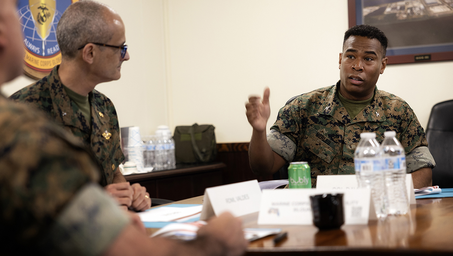U.S. Navy Rear Adm. Guido Valdes, the Medical Officer of the Marine Corps, listens to Marine Corps Col. David Merles, commanding officer Blount Island Command, during a brief on Marine Corps prepositioning programs 