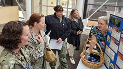 Patricia Skinner, Naval Hospital Bremerton Health Promotion and Wellness Center department head, shares information with staff members on one of their monthly themes