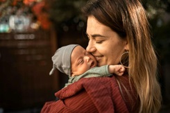 A mother carrying her child