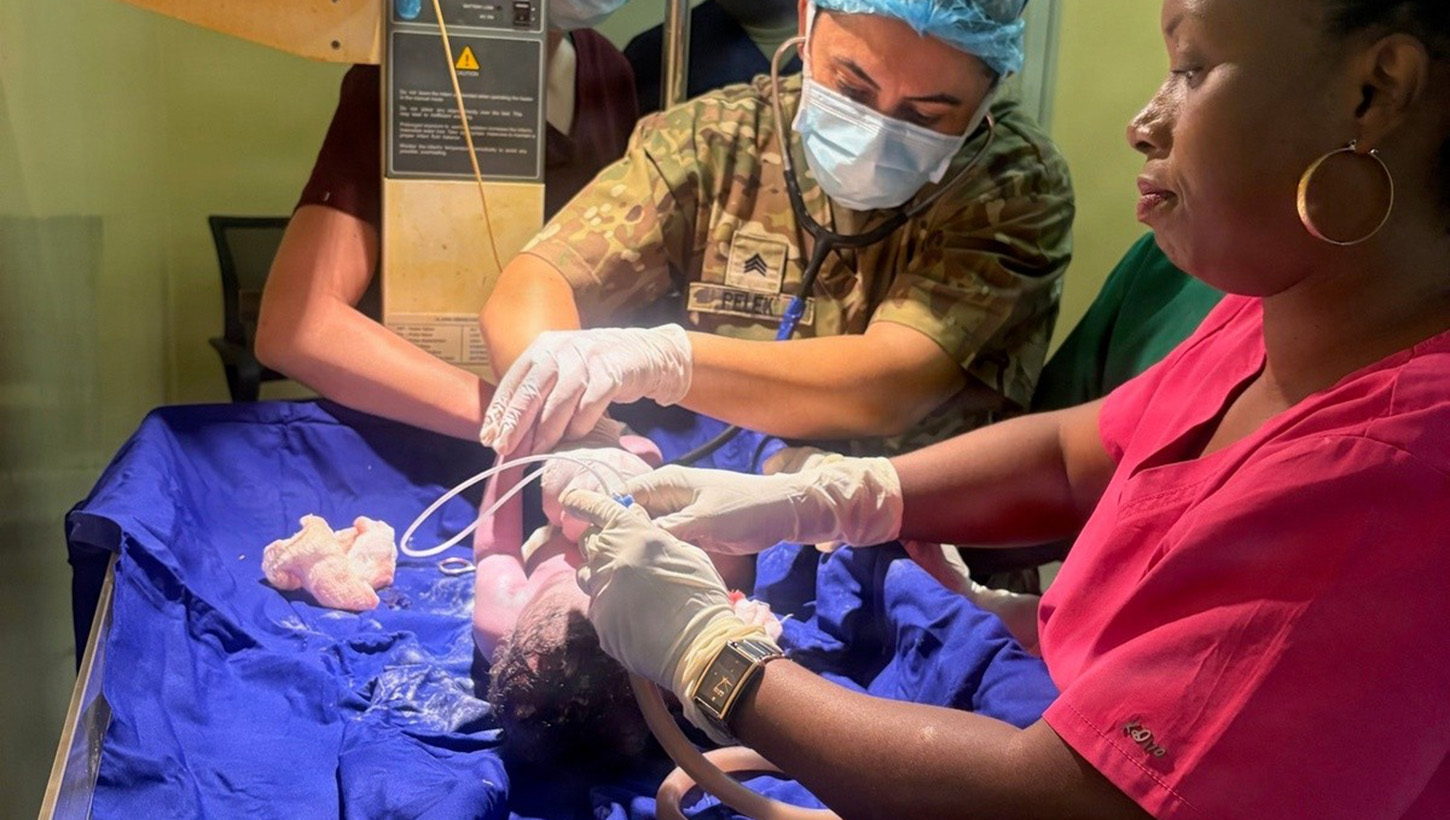 U.S. Army Sgt. Meltem Pelek with the 30th Medical Brigade, treats a patient alongside a Burundi National Defence Force medical professional during a medical readiness exercise at Kamenge Military Hospital, Bujumbura