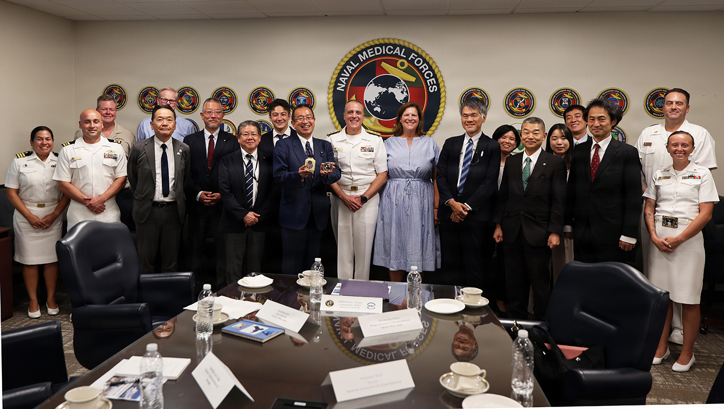 Leadership from Naval Medical Forces Pacific and members of a visiting Japanese health care delegation pose for a group photo