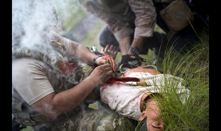 Link to Photo: U.S. Air Force Senior Airman Michael Triana, left, 347th Operations Support Squadron independent duty medical technician-paramedic, addresses injuries on a simulated patient during a tactical combat casualty care course, in Okeechobee, Florida. The course tests and reinforces participants’ lifesaving medical skills while they are in high-stress, combat scenarios. (U.S. Air Force photo by Staff Sgt. Ryan Callaghan)