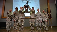 U.S. Army Brig. Gen. Yolonda “YR” Summons, commander, Command Sgt. Maj. Jennifer Francis, senior enlisted leader, Medical Readiness Command, West, Lt. Col. Marcos Martinez and Command Sgt. Maj. Angela Bowley, Medical Readiness Battalion, Brooke Army Medical Center command team, stand with Staff Sgt. Dominic Kochen, operating room technician, and Cpl. Nolan Wallace, practical nurse specialist, Brooke Army Medical Center, the 1st place winners of the 2024 Best Medic Competition in a Nov. 21 awards ceremony. (Photo by Rodny Jackson/Carl. R. Darnall Army Medical Center)