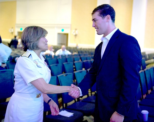 Navy Vice Adm. Raquel C. Bono greets retired Army Sgt. Oliver Campbell after his moving presentation at 2019 MHSRS about how he survived near-fatal gunshot wounds during a 2016 Afghanistan mission. (MHS photo)
