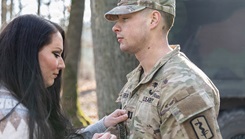 Peyton Lineberger pins the rank of captain onto her husband, Capt. Conor L. Lineberger, an Army nurse