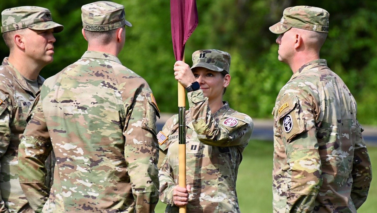 Capt. Crystal J. Absher holds the guidon as assumption of command orders are read during the U.S. Army MEDDAC, Fort Polk Medical Company change of command ceremony