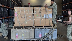 Preparing the Forward Deployable Preventive Medicine Unit (FDPMU) for shipment, members of the Expeditionary Medical Logistics directorate securely stow it prior to transport.