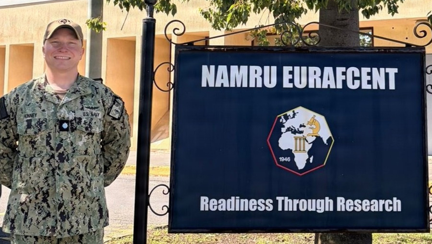 Cmdr. Micah Kinney, executive officer, Naval Medical Research Unit (NAMRU) EURAFCENT, poses outside of the command headquarters.