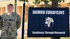 Cmdr. Micah Kinney, executive officer, Naval Medical Research Unit (NAMRU) EURAFCENT, poses outside of the command headquarters.