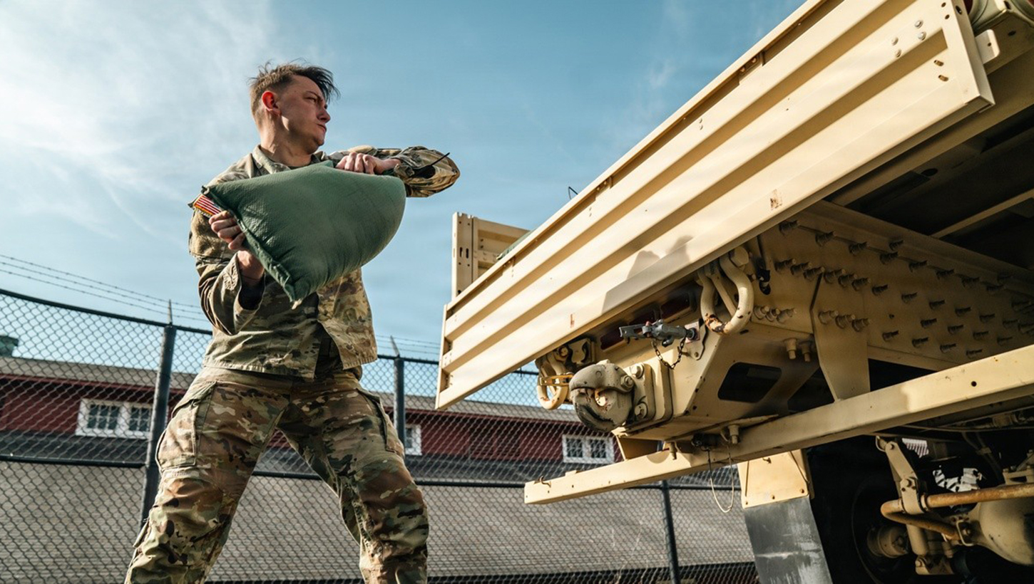 U.S. Army Sgt. Christopher Smith assigned to 1st Battalion, 3d U.S. Infantry Regiment (The Old Guard) lifts a 40-lbs sandbag during the new Combat Field Test