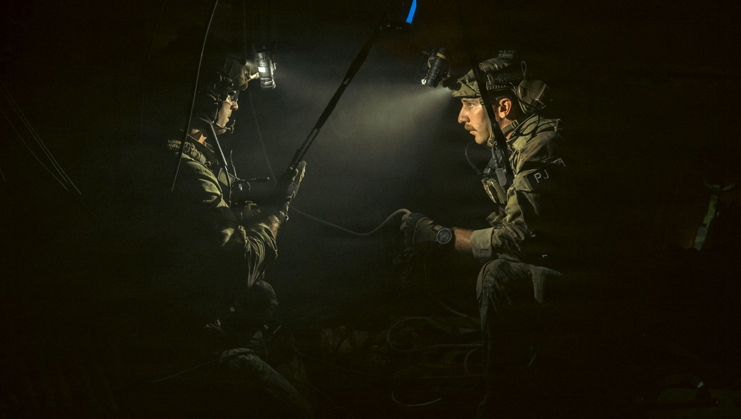 Air Force pararescuemen assigned to the 68th Rescue Squadron discuss a plan on how to proceed during a confined space rescue scenario 